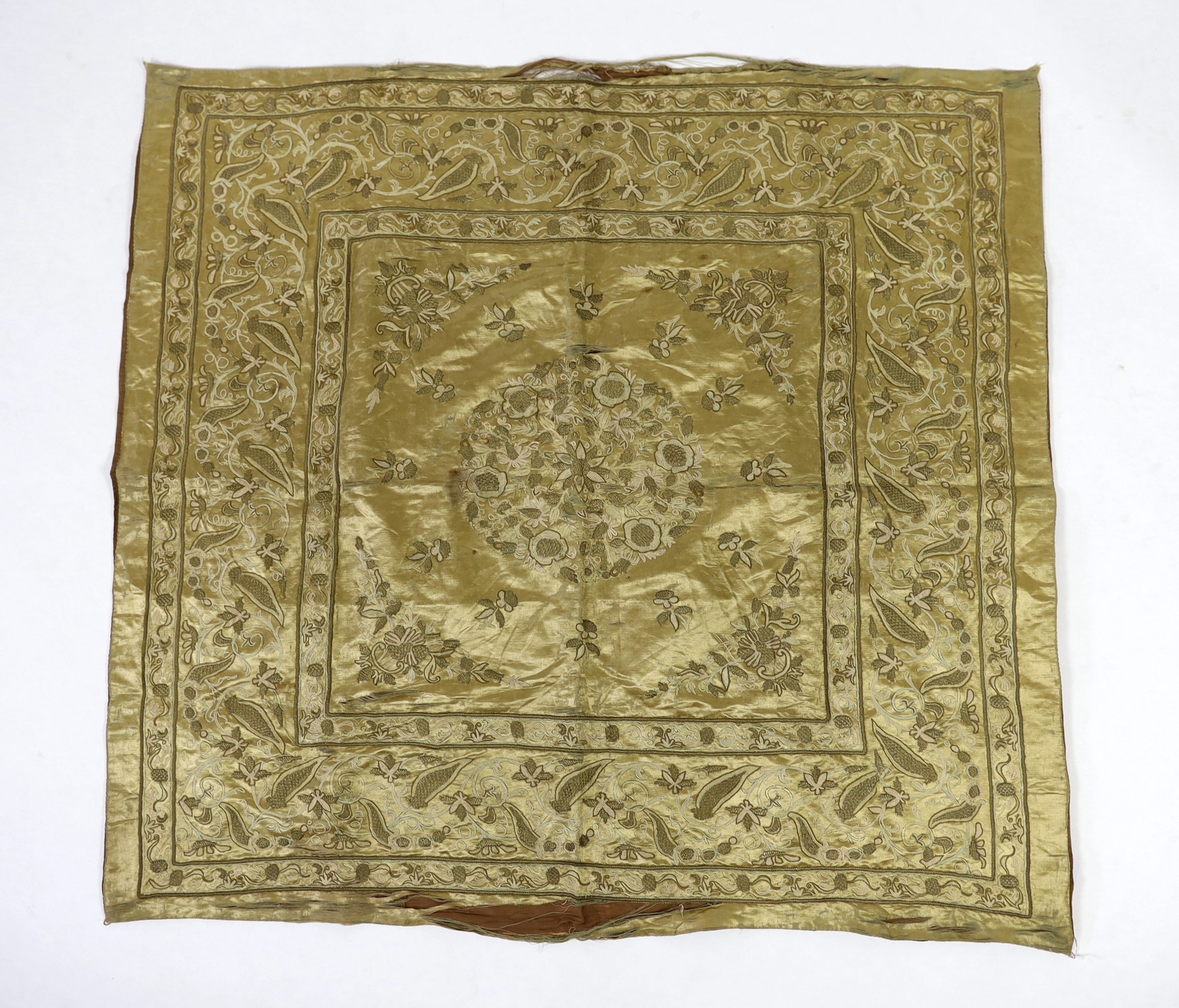 A late 19th century Turkish metallic thread and chain stitch silk satin cover, embroidered with a central cartouche of flowers and print, with rows of various borders with similar embroidery, 123 x 116cm